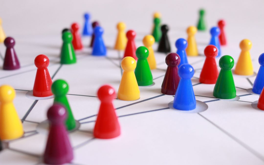 Different colored game pieces on connecting lines, image used for Ari Monkarsh blog on the benefits of networking